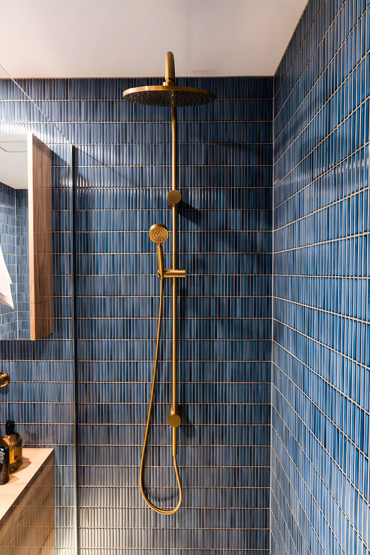 Modern Shower Area with Blue Vertical Tiles and Brass Fixtures | Material Depot